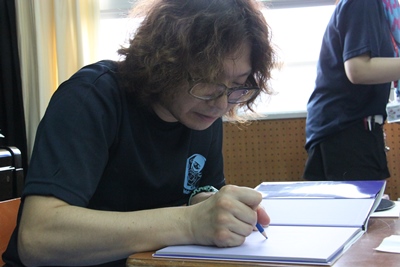 絵本にサインしている山本先生の写真